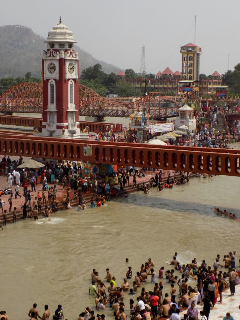 A vibrant scene of pilgrims bathing at the sacred Har Ki Pauri in Haridwar, India.