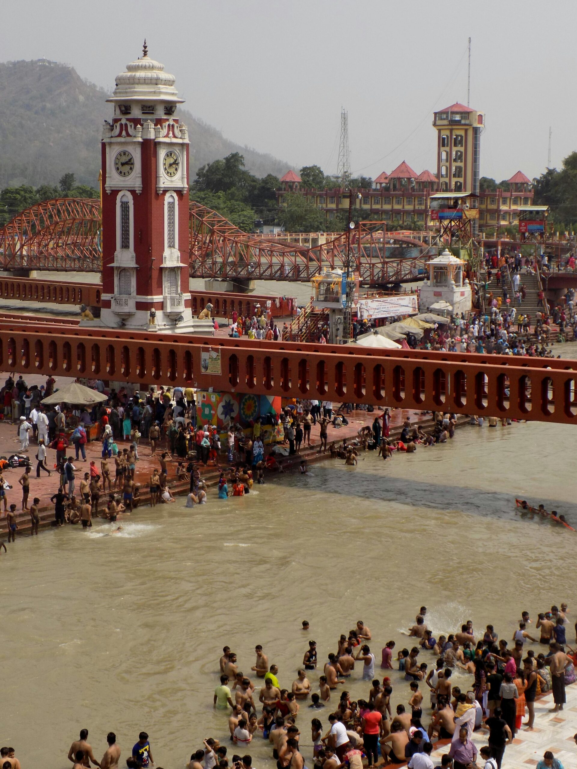 A vibrant scene of pilgrims bathing at the sacred Har Ki Pauri in Haridwar, India.